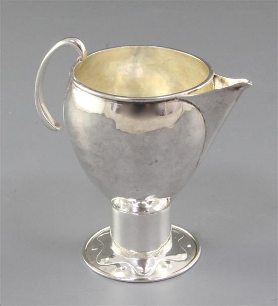 An Edwardian Arts & Crafts silver sparrow beak cream jug, Height 3 ¾”/90mm Weight 2.8oz/80grms